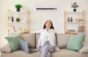 A woman enjoying the benefits of eco-friendly home renovation practices.